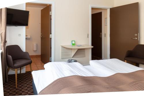 Ένα ή περισσότερα κρεβάτια σε δωμάτιο στο Foldens Hotel
