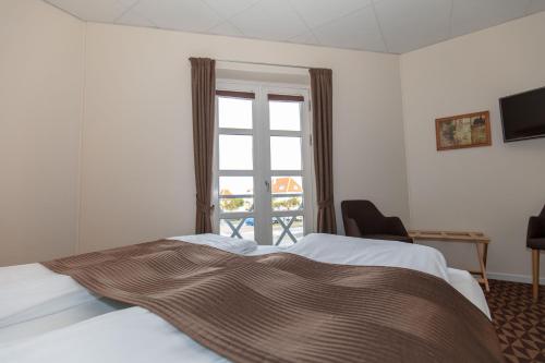 Ένα ή περισσότερα κρεβάτια σε δωμάτιο στο Foldens Hotel