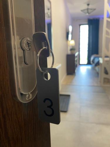 a door with a door tag on it with a room at Aparthotel Riva in Zawiercie