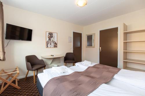 Ένα ή περισσότερα κρεβάτια σε δωμάτιο στο Foldens Hotel