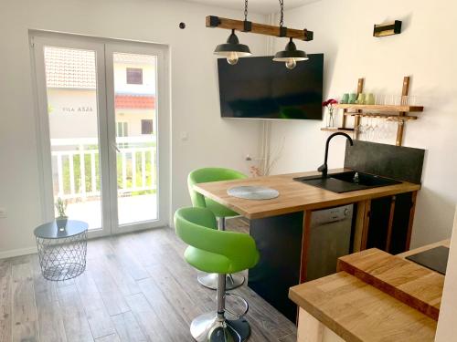 a kitchen with a table and a green chair at The perfect stay in Hvar