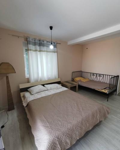 a bedroom with a large bed and a window at Holiday Home Kalicanin in Bar