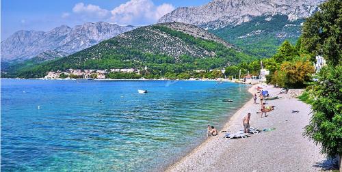 a group of people on a beach near the water at Casa Viter Zaostrog in Zaostrog