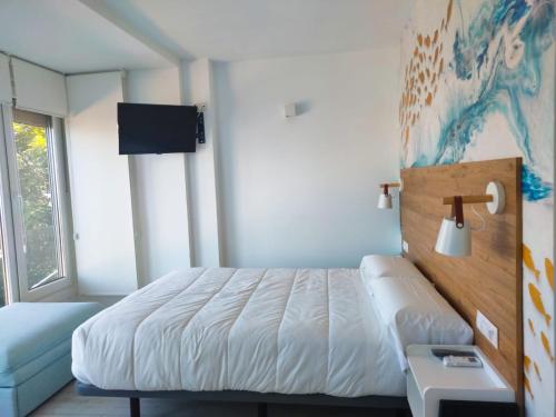 Ένα ή περισσότερα κρεβάτια σε δωμάτιο στο Hotel Rodeiramar 2A