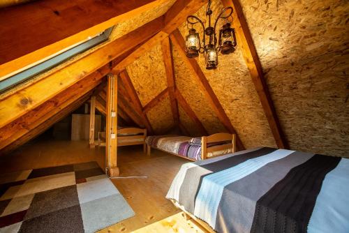 een zolderkamer met een bed en een raam bij VILLA MILENA in Kotor