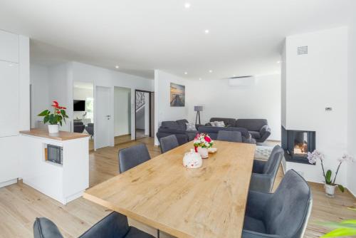 a dining room and living room with a table and chairs at Holiday home Čančar by SeeAdria Agency in Fiorini