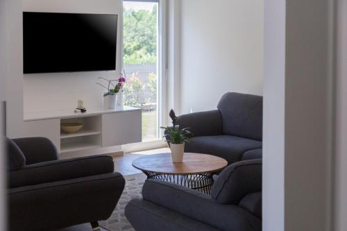 a living room with two couches and a table at Holiday home Čančar by SeeAdria Agency in Fiorini