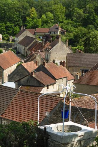 a view of roofs of a town with a street light at Le Domaine des Carriers in Chevroches