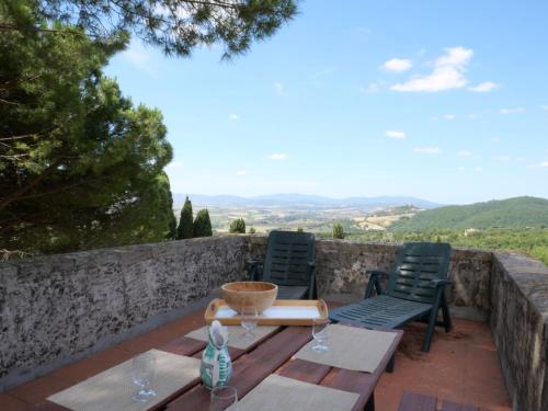 a table and chairs on a patio with a view at Apartment La Torre by Interhome in Podere Caminino