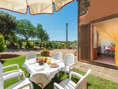 a table and chairs in the yard of a house at Apartment Leccio by Interhome in Preselle