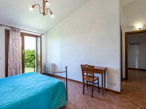 a bedroom with a bed and a desk and a chair at Apartment Leccio by Interhome in Preselle