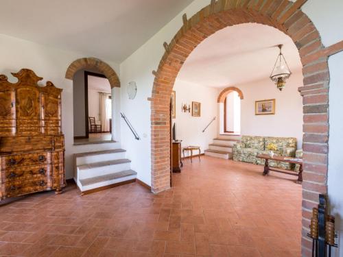 an archway in a living room with a couch and stairs at Apartment Leccio by Interhome in Preselle