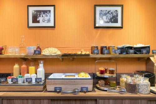 a buffet line with food on display in a restaurant at Hotel Boris V. by Happyculture in Levallois-Perret