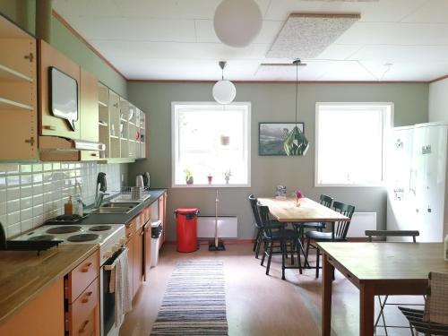 a kitchen with a table and a dining room at Magic Mountain Lodge - Lyngen in Lyngseidet