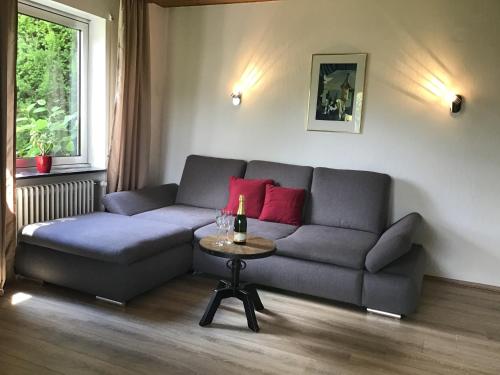 a living room with a couch and a table at Ferienwohnung Panoramablick in Rimbach