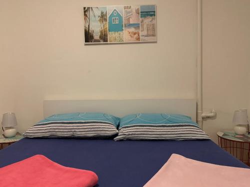 a bed with two pillows on top of it at Apartment Florian in Rijeka