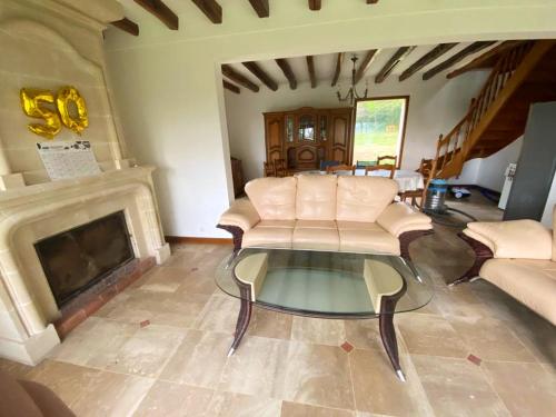a living room with a couch and a coffee table at Maison de caractère à Mouterre-Silly avec grand jardin in Mouterre-Silly