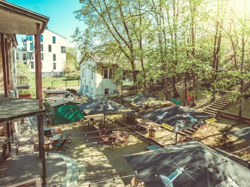 an overhead view of a patio with tables and umbrellas at Downtown Forest Hostel & Camping in Vilnius