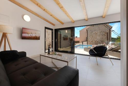 a living room with a couch and a table at Villa Luigi with a pool in Cavtat