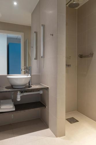 a bathroom with a sink and a shower at Elite Hotel Ideon, Lund in Lund