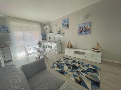 a living room with a couch and a table at Las Floridas Apartment in Alghero