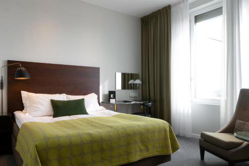 a hotel room with a bed and a chair at Elite Hotel Ideon, Lund in Lund