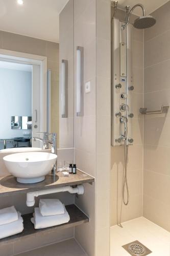 a bathroom with a sink and a shower at Elite Hotel Ideon, Lund in Lund