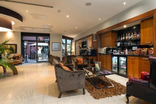 a living room with a bar and a lobby at The Chambers in Leeds