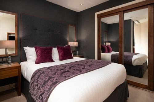 a hotel room with a large bed and a mirror at The Chambers in Leeds
