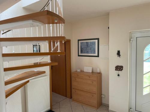 a room with a spiral staircase and a dresser at Ferienhaus Mücheln in Mücheln