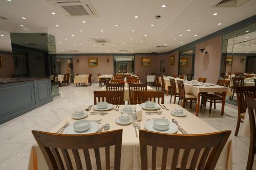 a dining room with tables and chairs in a restaurant at Mineo Hotel Taksim in Istanbul