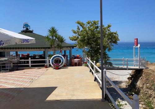 a restaurant on the beach next to the ocean at Villa John in Borsh