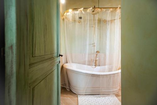 a bath tub in a bathroom with a shower at Fattoria Le Fonti in Poggibonsi