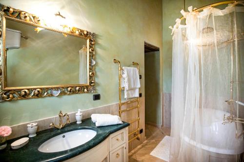 a bathroom with a sink and a shower with a mirror at Fattoria Le Fonti in Poggibonsi