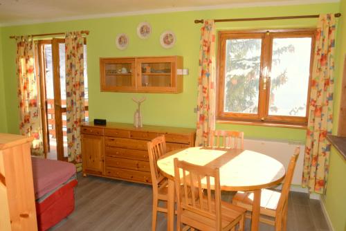 a kitchen with a table and chairs in a room at House La Motta by Holiday World in Borgata Sestriere