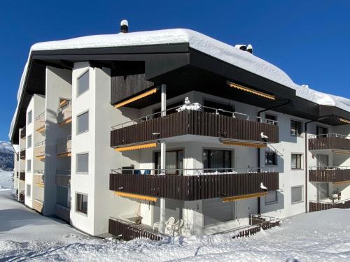 a building with snow on the ground in front of it at Apartment Triangel D Sieben by Interhome in Parpan
