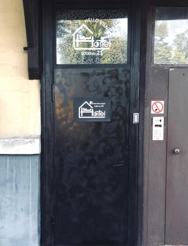 a black door with a sticker on it at HelloVilniusHostel in Vilnius