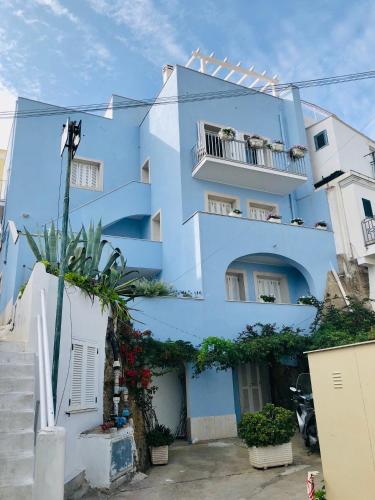 a blue apartment building with a balcony at Villa Marisa - La Guarida in Ponza