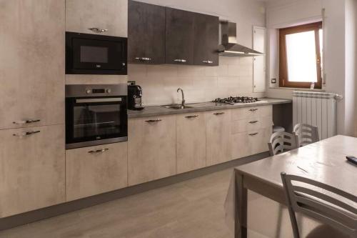 a kitchen with a sink and a stove top oven at Affittacamere Al Corso in San Martino dʼAgri