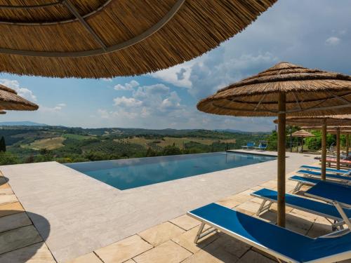 a villa with a swimming pool and umbrellas at Holiday Home Borgo by Interhome in Monte Antico