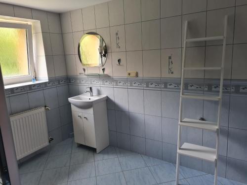 a bathroom with a sink and a mirror at Apartament pod wieżą Sky Walk in Świeradów-Zdrój