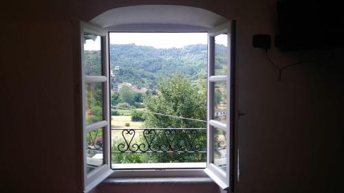 an open window with a view of a forest at La Torretta in Beverino
