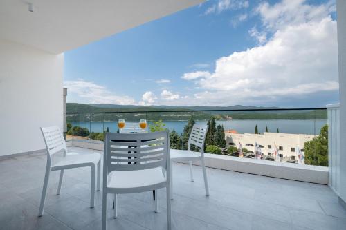 a balcony with a table and chairs and a view of the water at Marea Hotel & Spa in Neum