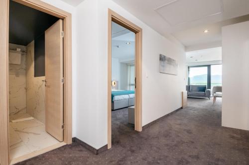 a room with a door leading to a bedroom at Marea Hotel & Spa in Neum