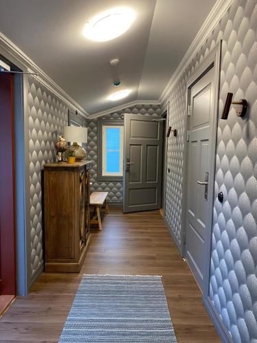 a hallway with a door and a rug at Eleonora Bed & Breakfast in Kristiinankaupunki