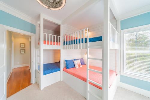 a room with a bunk bed and a ladder at Inlet Blue Home in Inlet Beach