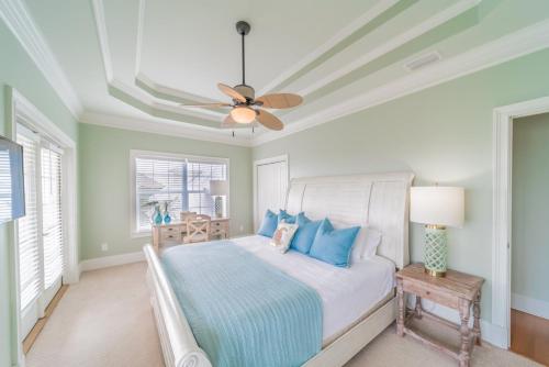 a bedroom with a bed and a ceiling fan at Inlet Blue Home in Inlet Beach