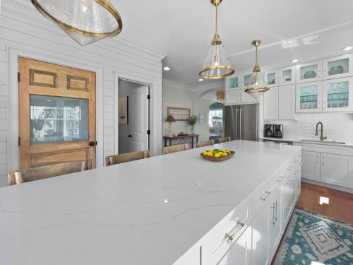 a kitchen with white cabinets and a white counter top at Inlet Blue Home in Inlet Beach