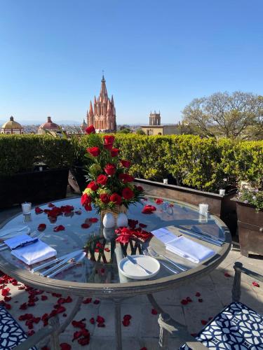 a glass table with a vase of flowers on it at Casa de Sierra Nevada, A Belmond Hotel, San Miguel de Allende in San Miguel de Allende