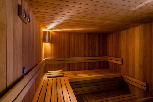 an empty wooden sauna with a light on the inside at Penzion Čertovy skály in Lidečko